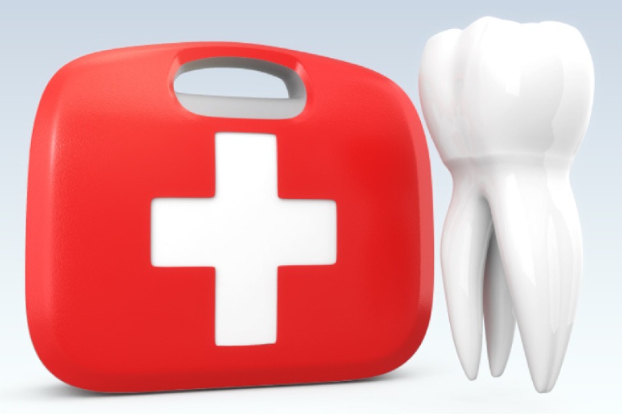 Red emergency dental kit next to a model of an oversized tooth.